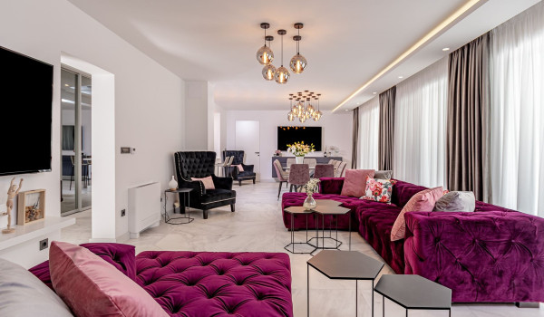 Spacious living area with living room and dining room filled with light inside Croatian luxury holiday villa