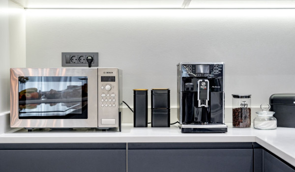 Microwave and coffee machine in the modern spacious kitchen this villa with pool