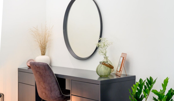 A seating corner with mirror in the modern bedroom of the luxury villa Velvet Bourbon Split with pool