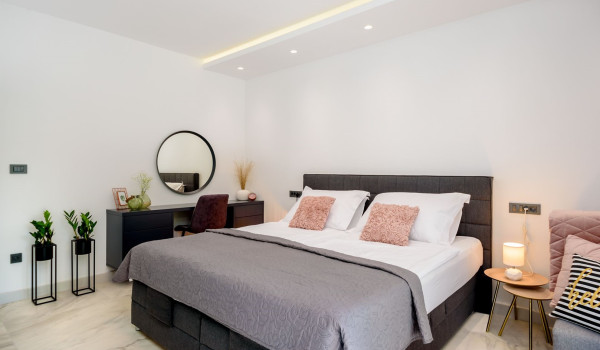 Bedroom with king size bed and seating area inside Croatian luxury holiday villa
