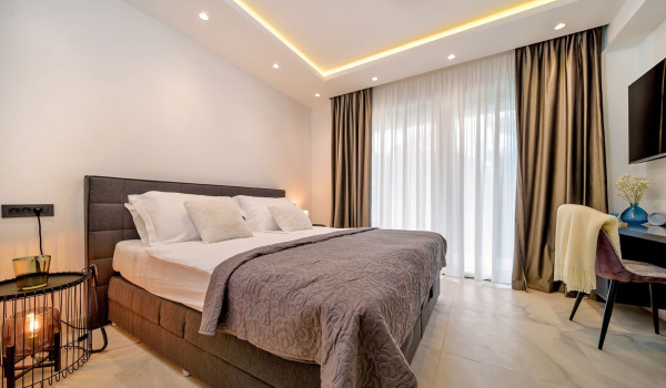 Modernly decorated bedroom with a comfortable king size bed and LCD TV