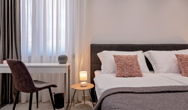 Seating area next to the comfortable king size bed in the bedroom inside Croatian luxury holiday villa