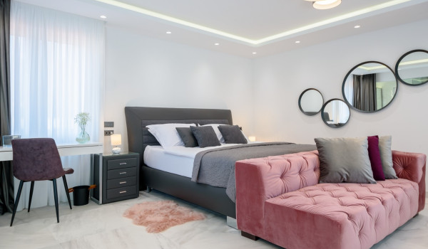 Contemporary bedroom interior with king size bed and seating area