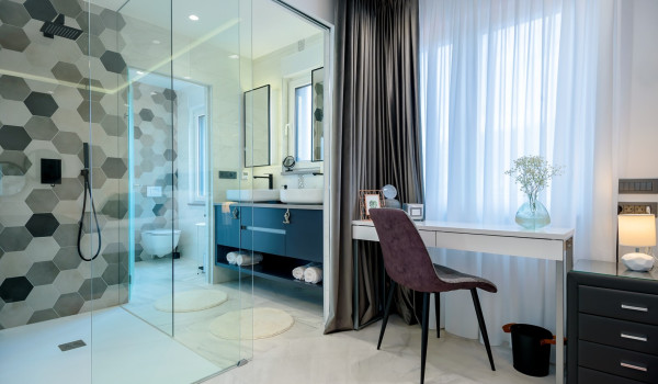 Glass wall that separates the bedroom from the private en suite bathroom with walk in shower