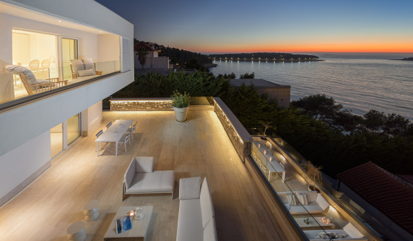 A view of the outdoor terrace with deckchairs and sofas and a view of the sea in Croatia luxury villa for rent Primosten Glamour