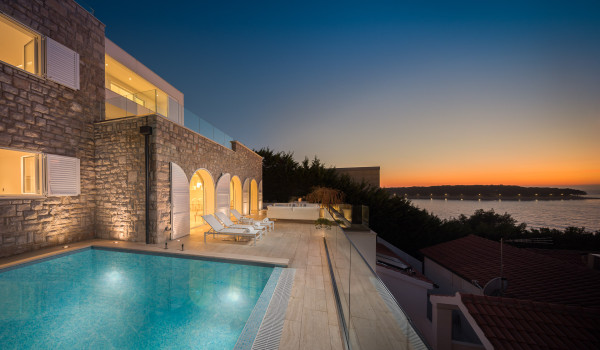 Private outdoor pool surrounded by deck chairs on the outdoor terrace with a view of the sea in the luxury Dalmatia holiday villa Primosten Glamour