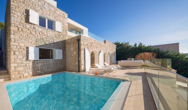 A view of the outdoor private pool surrounded by deckchairs on the outdoor terrace of the luxury private villa Primosten Glamour