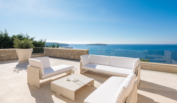 Seating set on the outdoor terrace with a view of the sea in a luxury villa with a private pool in Primošten