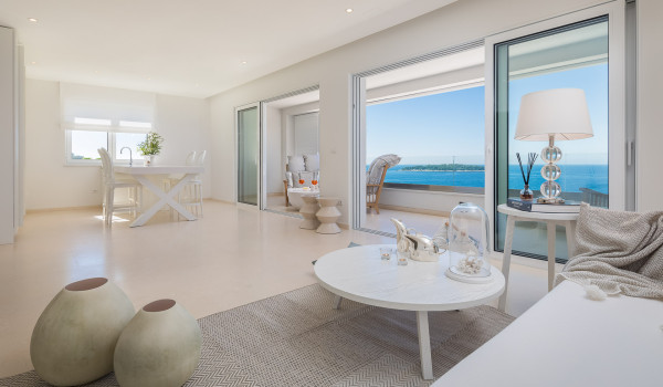 The interior of Croatia luxury villa Primosten Glamour with a sofa, a dining table with chairs and a private exit to the balcony