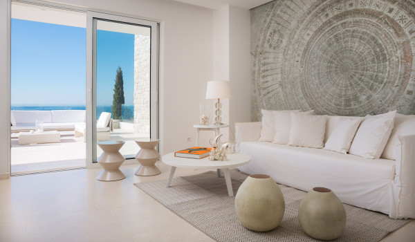 The living room of Croatia luxury villa Primosten Glamour with a sofa, coffee table and its own exit to the balcony with sea view