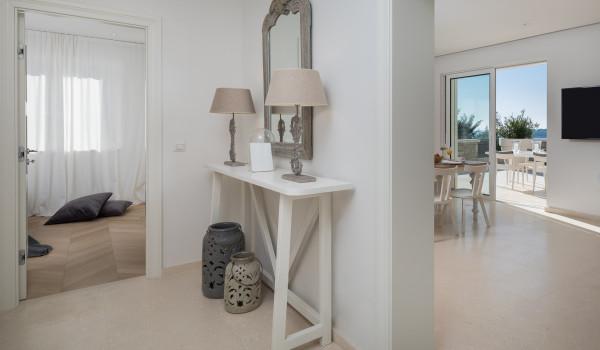 The interior of Croatia luxury rental villa Primosten Glamour with an entrance to the bedroom and a living room with access to the balcony