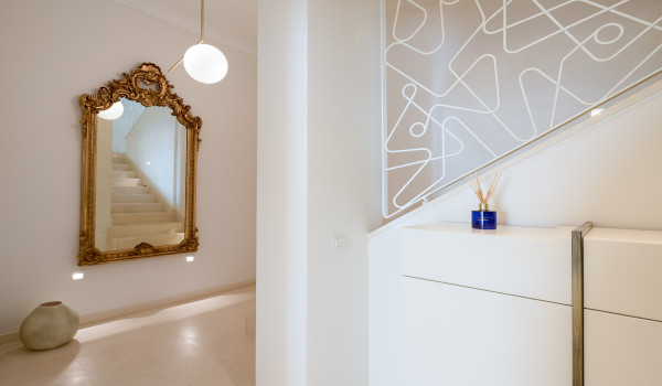 Hallway decorated with a baroque-style mirror and stairs leading to the first floor of Croatia pool villa in Primosten