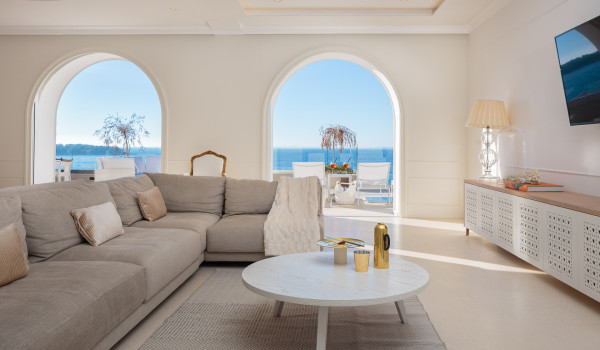 A spacious dining table with coffee table, LCD TV and exit to the outdoor terrace of Croatia luxury family villa overlooking the sea