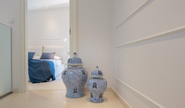 A view of the bedroom with a double bed and decorative vases in the luxury Croatia villa by the sea Primosten Glamour