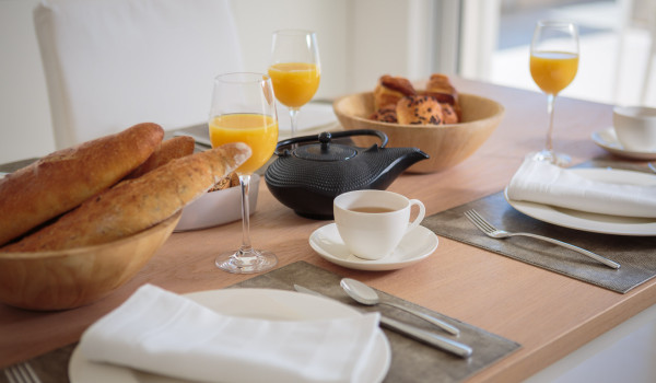 Rich breakfast served on the dining table in the luxury Dalmatia pool villa by the sea in Primosten