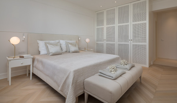 A bedroom with a double bed and a large wardrobe in the luxury villa for rent Primosten Glamour in Primosten