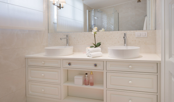 White dressing table with double sink and large mirror in the modern bathroom of Croatia luxury vacation villa in Primosten