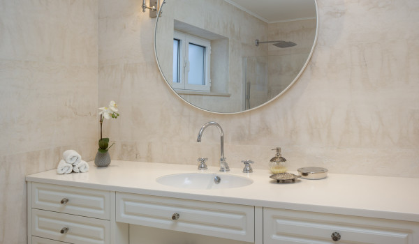Dressing table with sink and round mirror in the bathroom of Croatia luxury villa with private pool in Primosten
