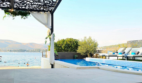 Luxury beachfront villa for rent with 2 pools - deck chairs by the  heated pool