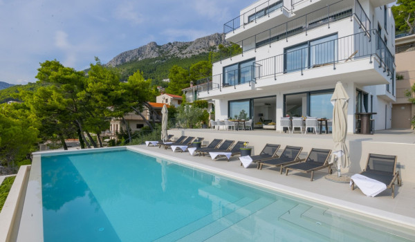 Exterior of Glorious Brela luxury villa with private heated pool and outdoor terrace with sun deck and deckchairs in Brela