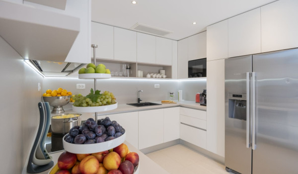 Kitchen equipped with fridge, oven and sink in a luxury vacation villa in Brela