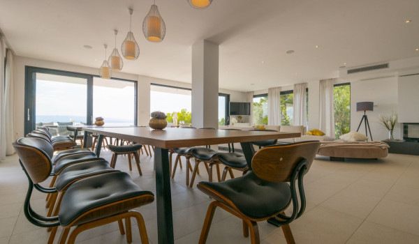 A dining area with a dining table and chairs in the luxury villa for vacation and rental Glorious Brela in Brela