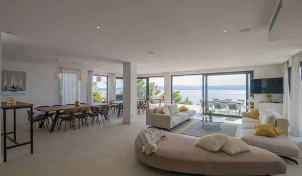 The interior of the luxury villa for rent Glorious Brela in Brela with a living room with a sofa and access to an outdoor terrace with a sea view