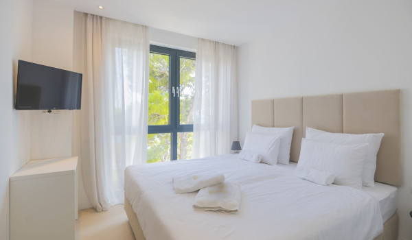 Bedroom with double bed and LCD TV in luxury villa with sauna Interior of luxury villa for rent Glorious Brela in Brela