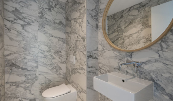 Mirror, sink and toilet in the bathroom in the luxury villa for rent Glorious Brela in Brela