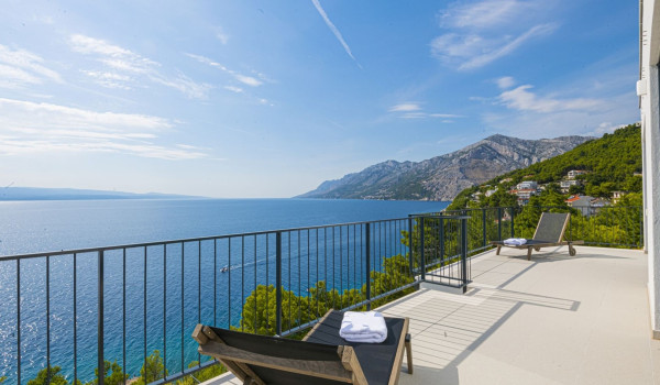 Sunbeds on the balcony overlooking the sea in the luxury holiday villa with private pool Glorious Brela in Brela