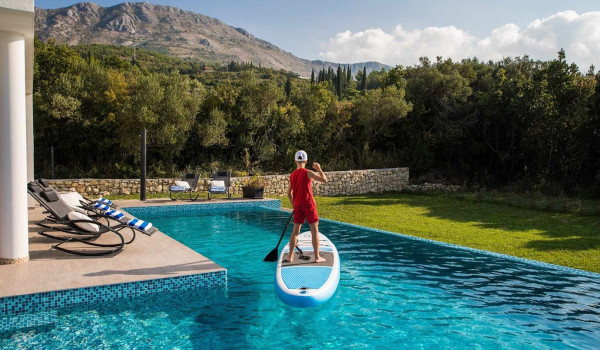 Stand-Up Paddling in a private pool on the terrace of a luxury Croatia family holiday villa near Dubrovnik