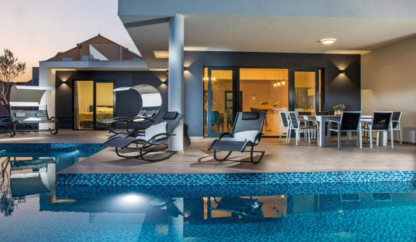 Sun loungers and seating area by the pool of the luxury holiday villa near Dubrovnik with concierge service