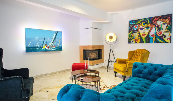 Living room with colourful sofas in a luxury vacation villa Quiet Land near the beach