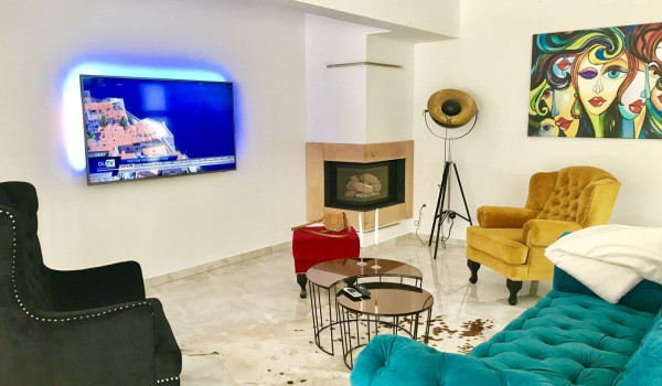 Living room with colourful sofas in a luxury vacation villa Quiet Land near the beach