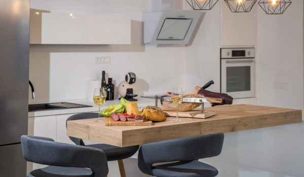 Kitchen island with traditional snacks, cheese and prosciutto in the kitchen of a luxury villa with concierge service and private pool near Dubrovnik