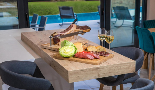 Kitchen island with traditional snacks, cheese and prosciutto in the kitchen of a luxury villa with concierge service and private pool near Dubrovnik