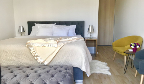 Bedroom with double bed, armchairs and access to the balcony in the luxury villa Mlini Quiet Land near Dubrovnik with concierge service and parking