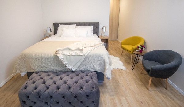 Bedroom with double bed, armchairs and access to the balcony in the luxury villa Mlini Quiet Land near Dubrovnik with concierge service and parking