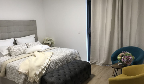 Bedroom with double bed,  armchairs and access to the balcony in the luxury villa Mlini Quiet Land near Dubrovnik with concierge service and parking