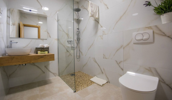 Modern bathroom with walk-in shower, sink and toilet in the Luxury family villa for vacation near Dubrovnik with private pool