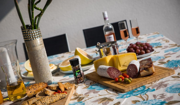 Traditional breakfast on the outdoor dining table in the Croatia luxury villa for family vacation near Dubrovnik