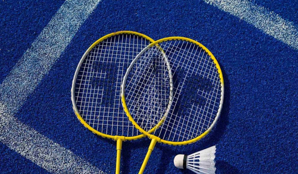 Badminton rackets on the court in front of a luxury Croatia holiday villa with a private pool near Dubrovnik